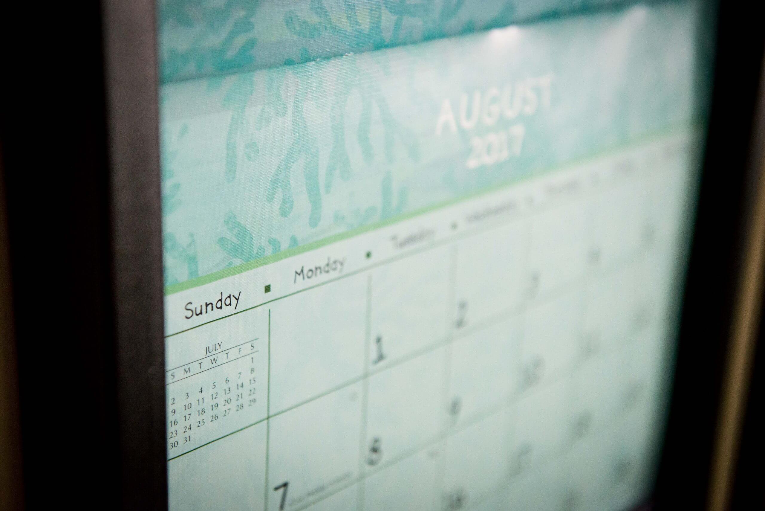 A blurred view of a calendar on the month of August.