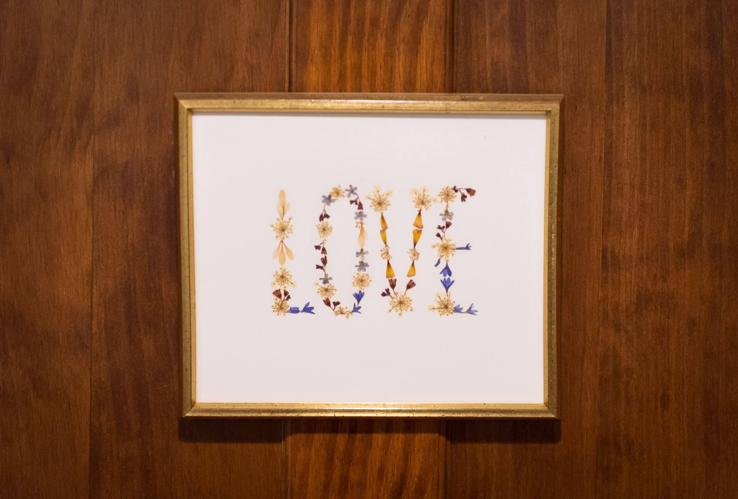 An framed illustration includes creative lettering of the word love.