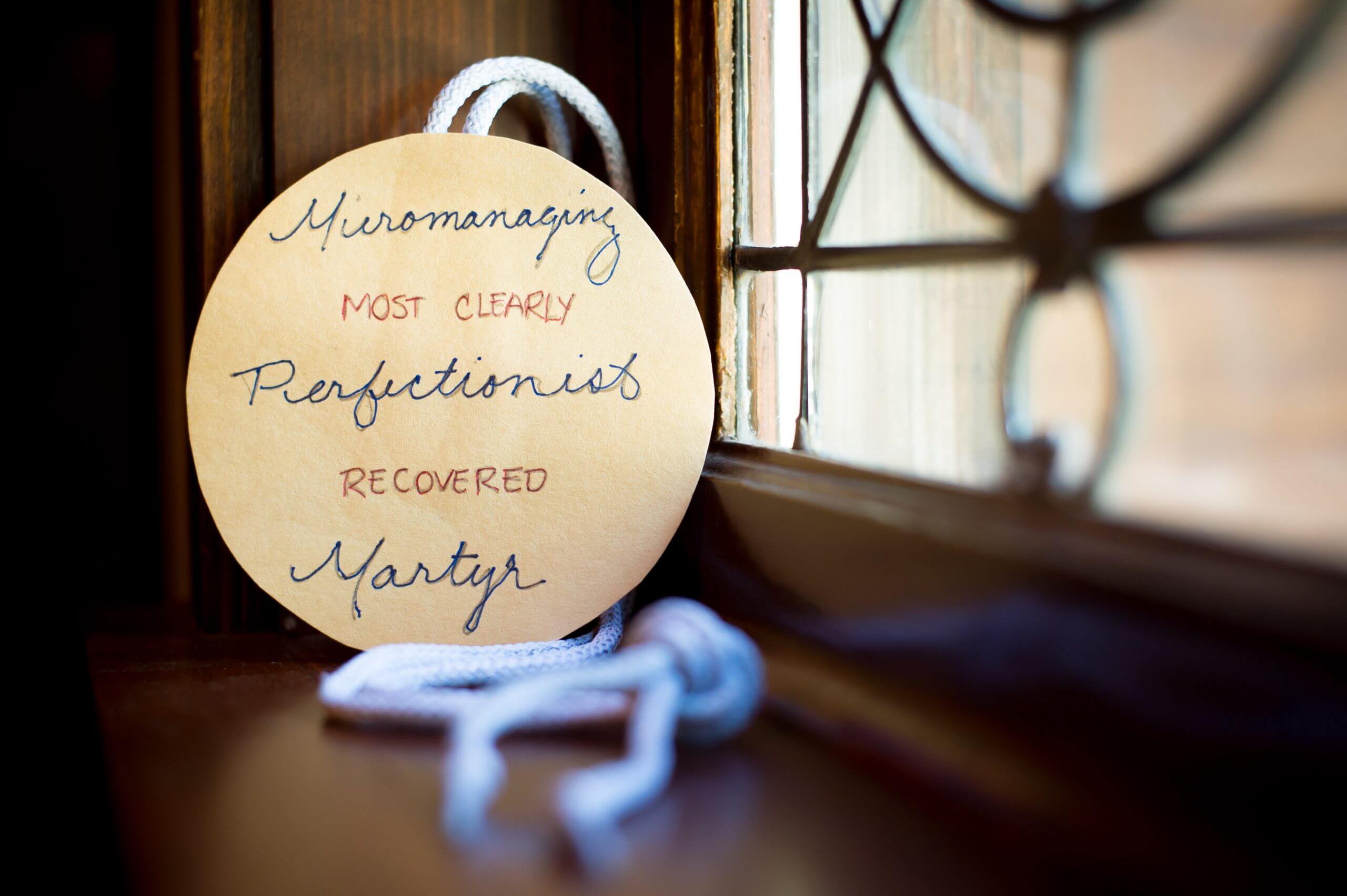A focused view of an award with an unfocused view of a knotted rope behind it. The award reads "Most Clearly Recovered. Micromanaging, Perfectionist, Martyr."