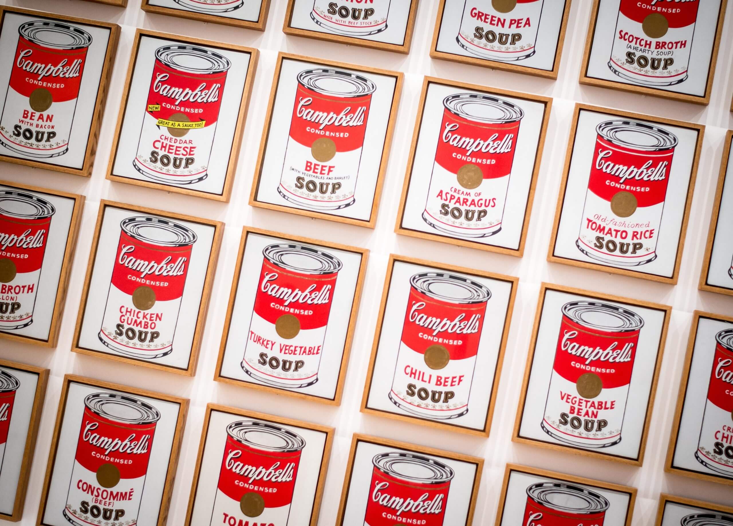 A photo of illustrations of Campbell's soup cans on a wall.
