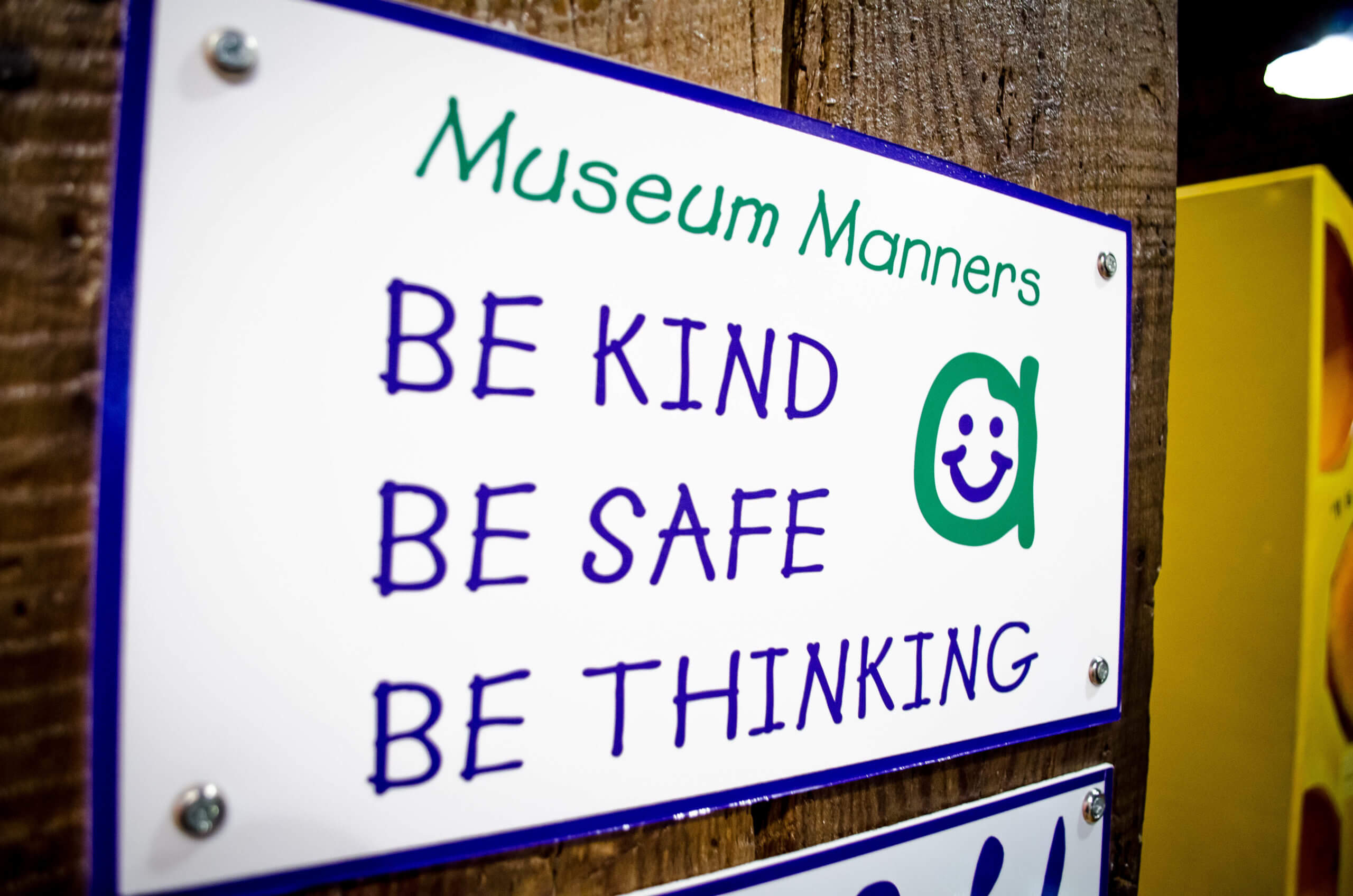 A sign reads "Museum Manners. Be kind. Be safe. Be thinking."