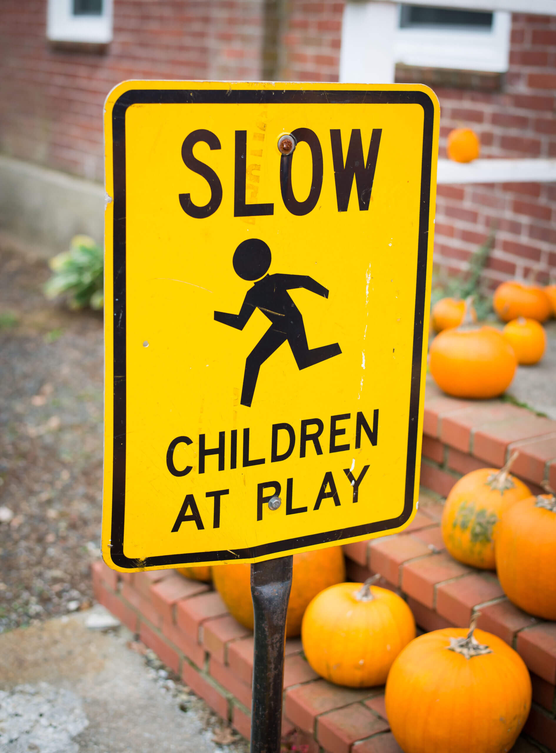 A street sign reads "Slow. Children At Play."