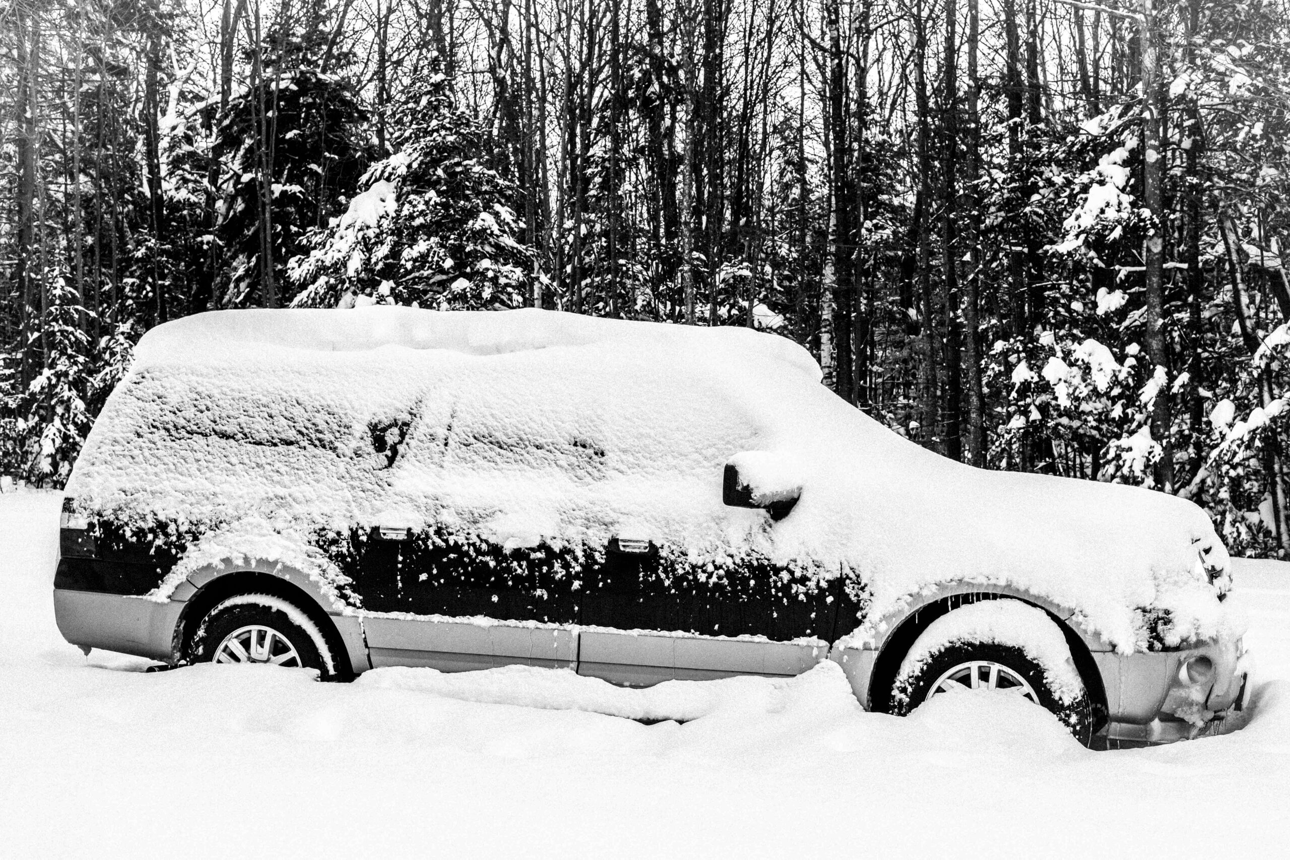 A snow covered SUV.