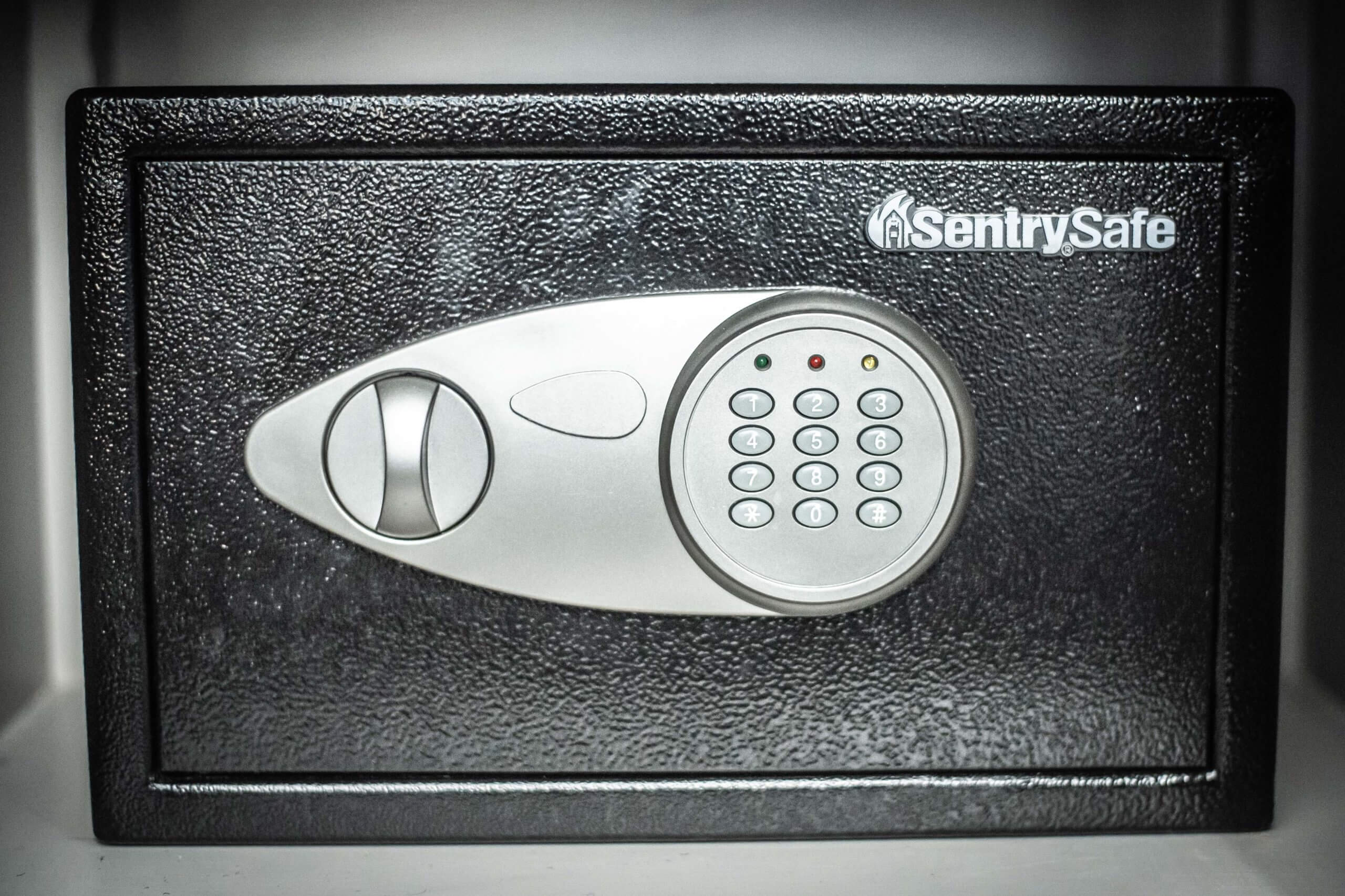 Photo of an eighteen by twelve inch black safe in a grey cabinet