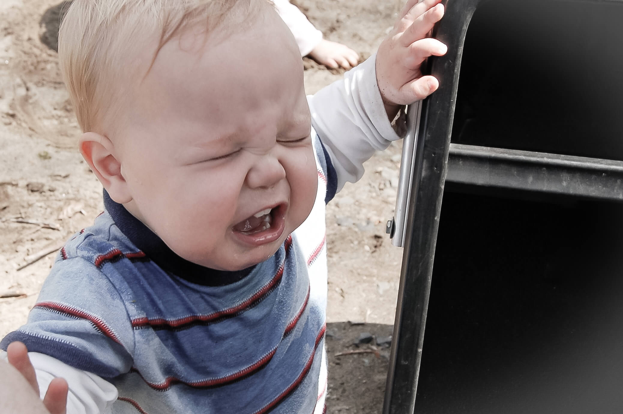 Close-up on a white full-faced toddler boy crying his eyes out.