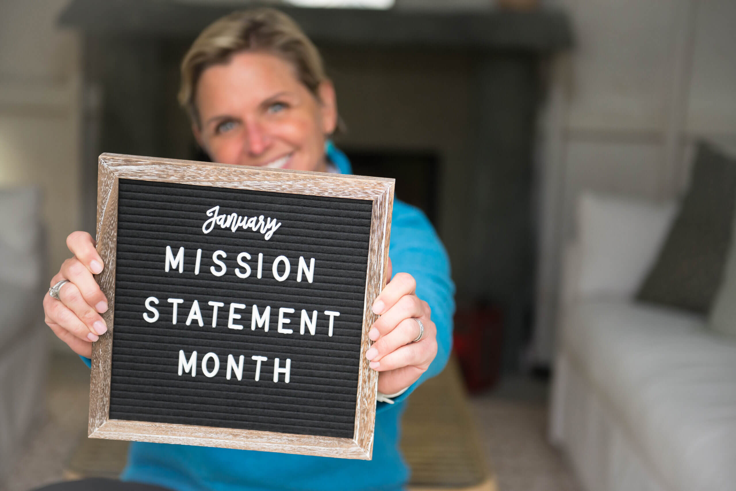 Mags in the background, in the foreground a sign reads "January Mission Statement Month"