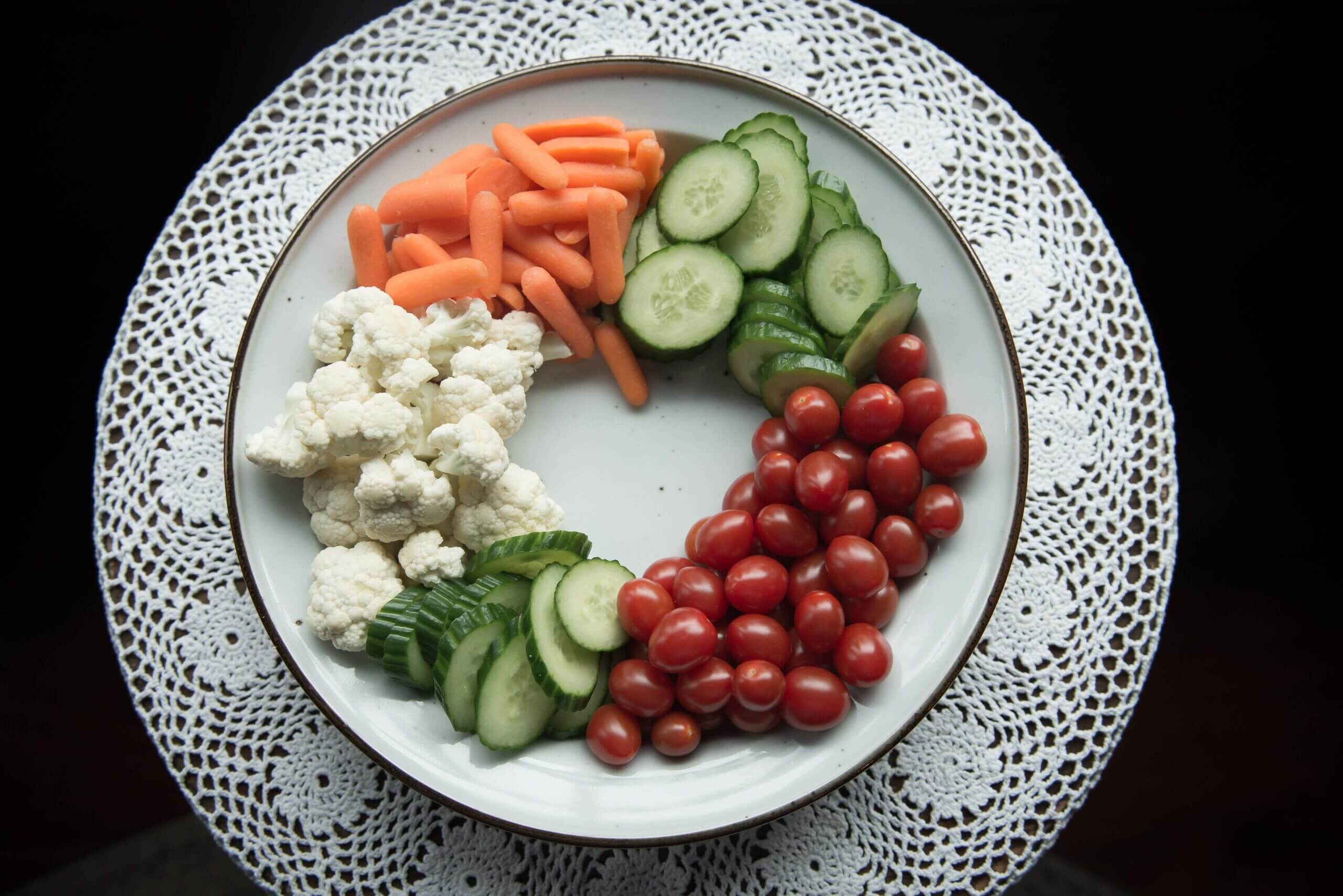Platter of vegetables with the share of a heart of no vegetables in the middle.