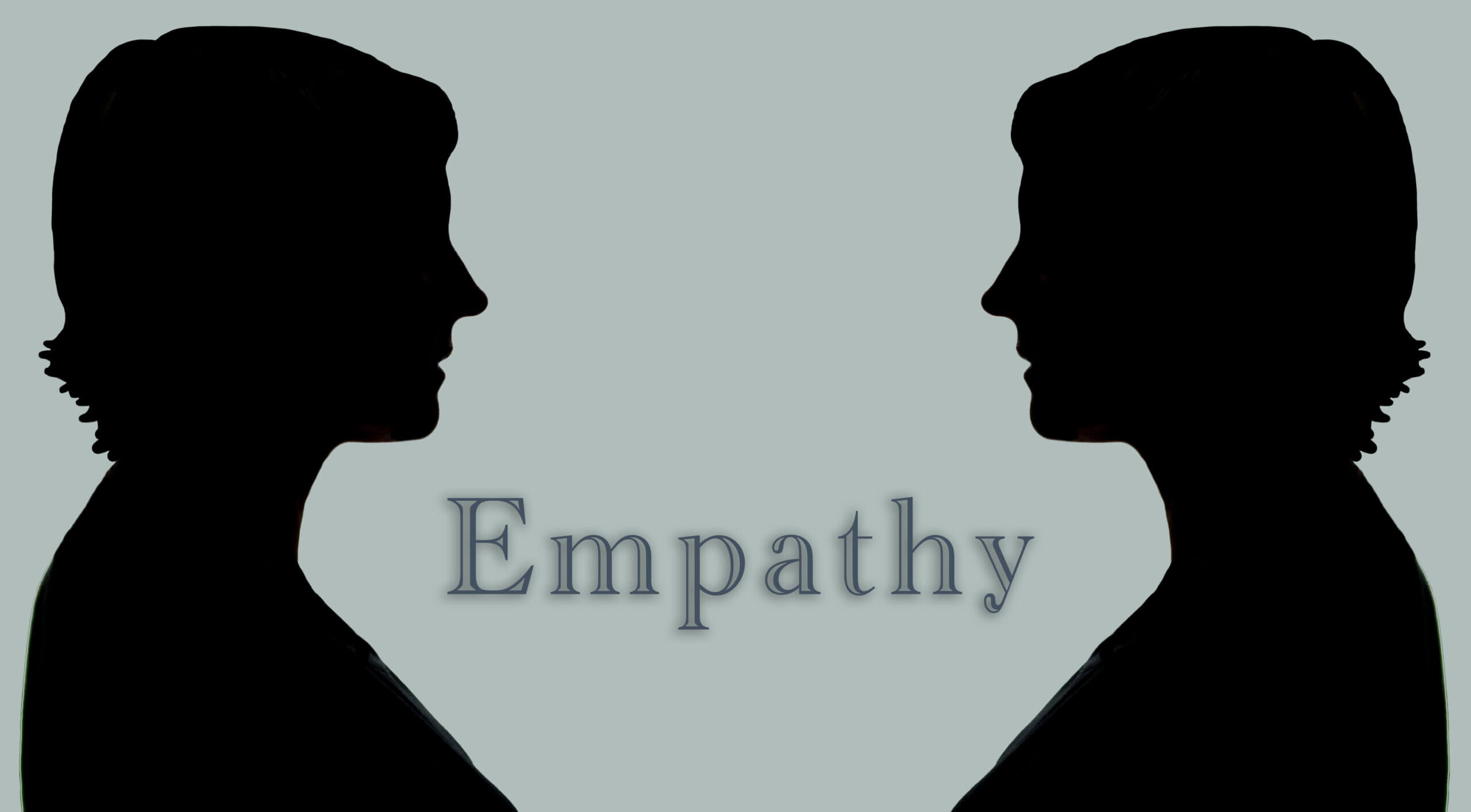 Two completely black silhouettes of the same woman facing each other with the word "Empathy" in the middle.