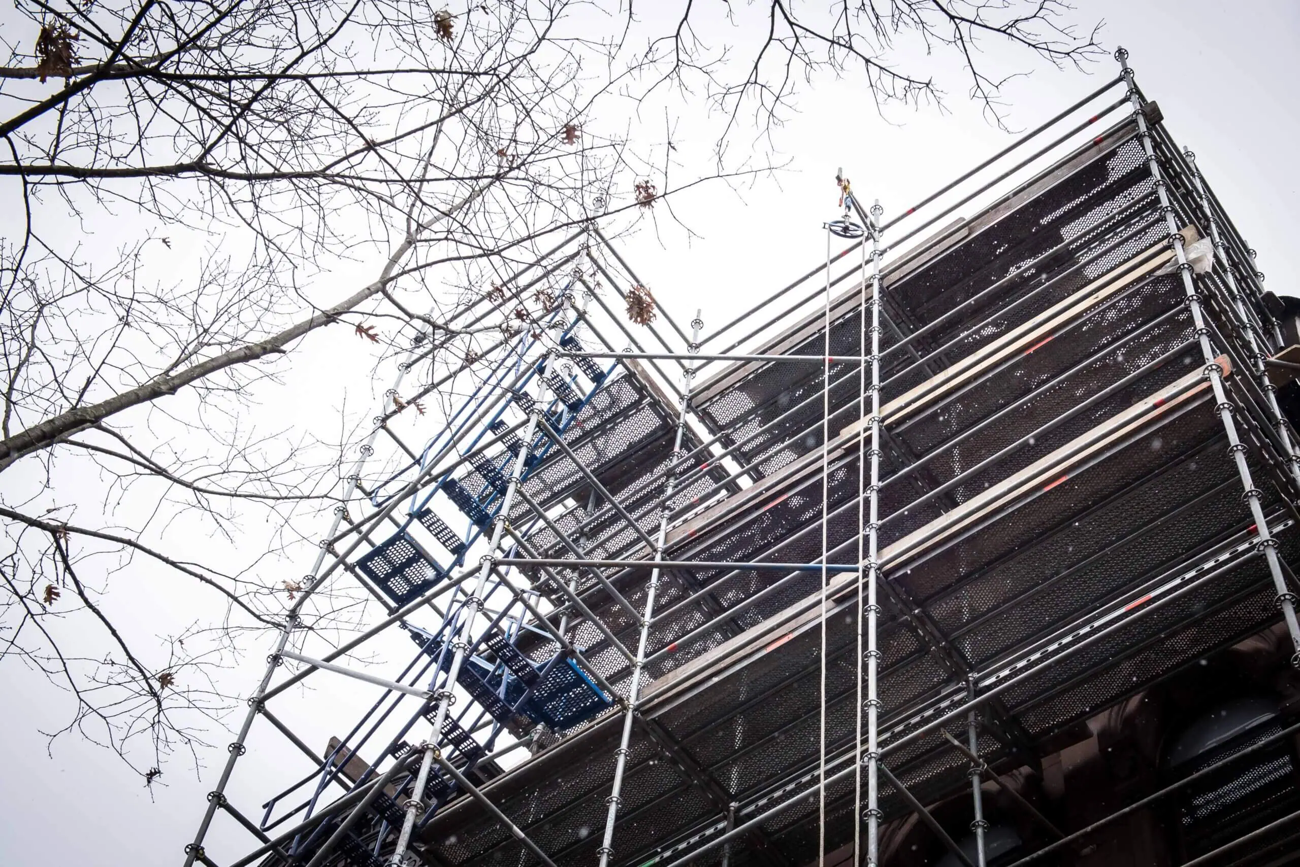 Image of scaffolding on a brownstone building.