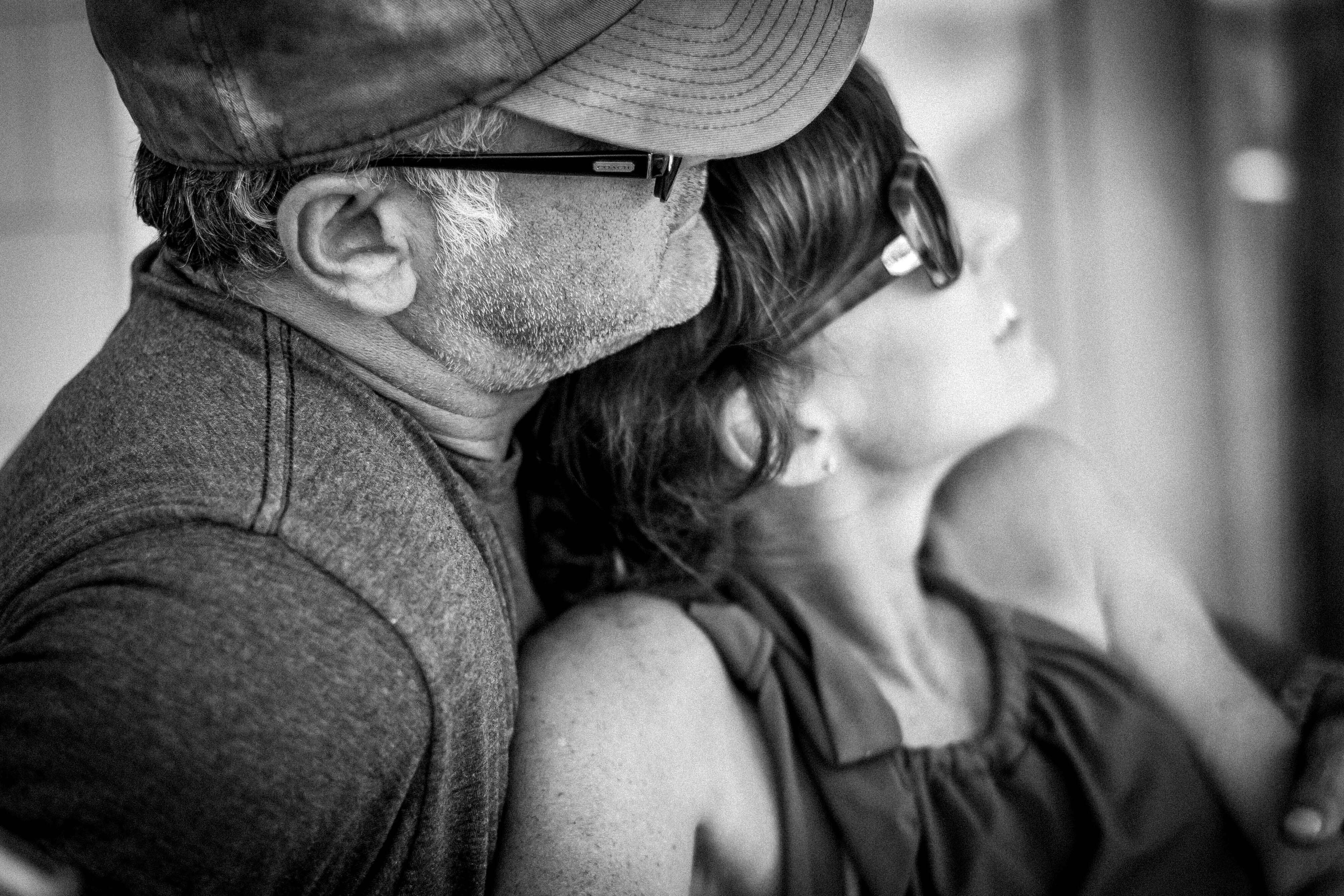 Close up black and white image of a white couple in their 50's in profile.